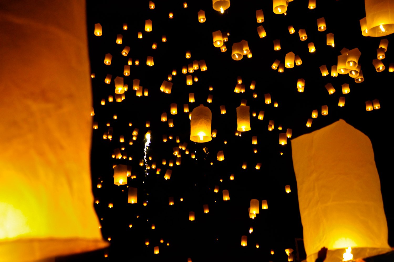 Launching rice paper hot air balloons during the Loi Krathong festival in Chiang Mai, Thailand.