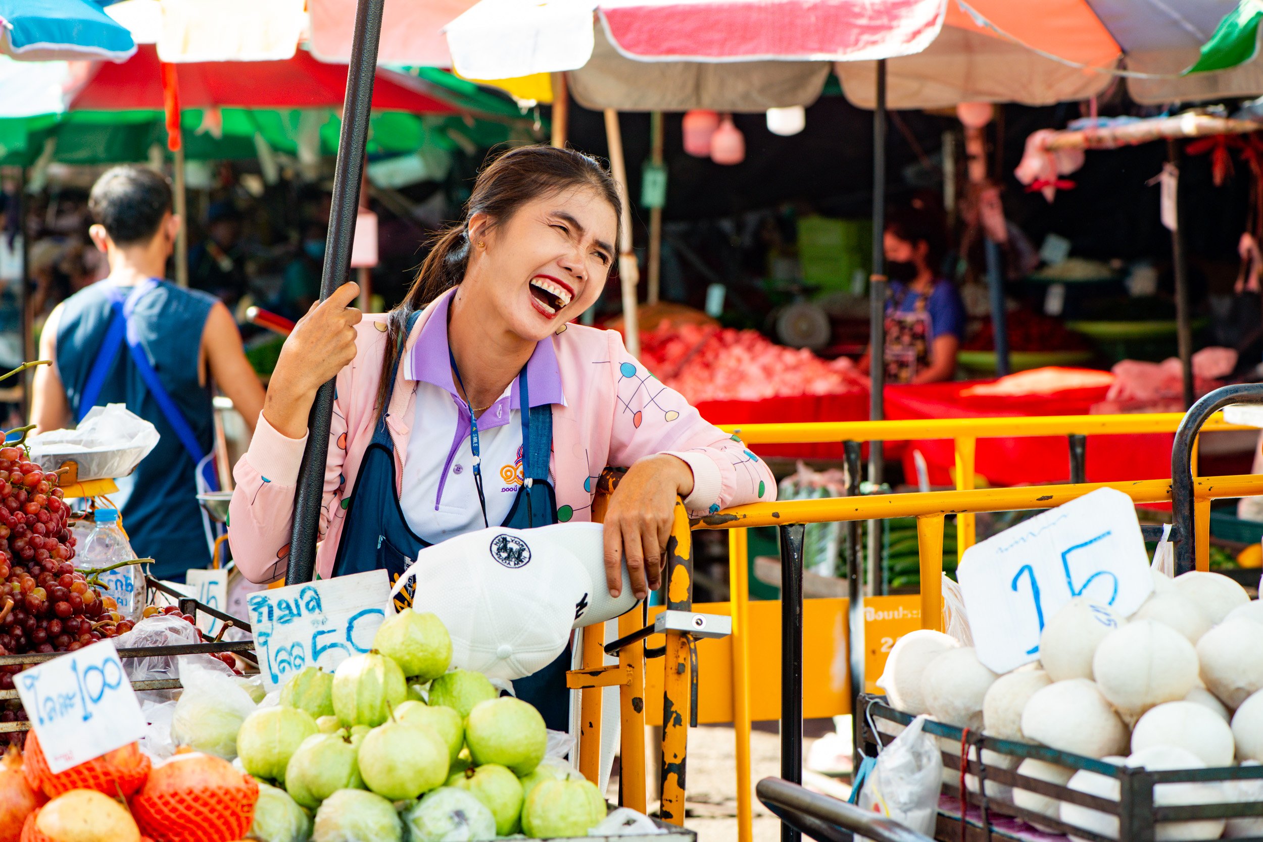 female market vendor laughing, Chiang Mai, Thailand, © Kevin Landwer-Johan